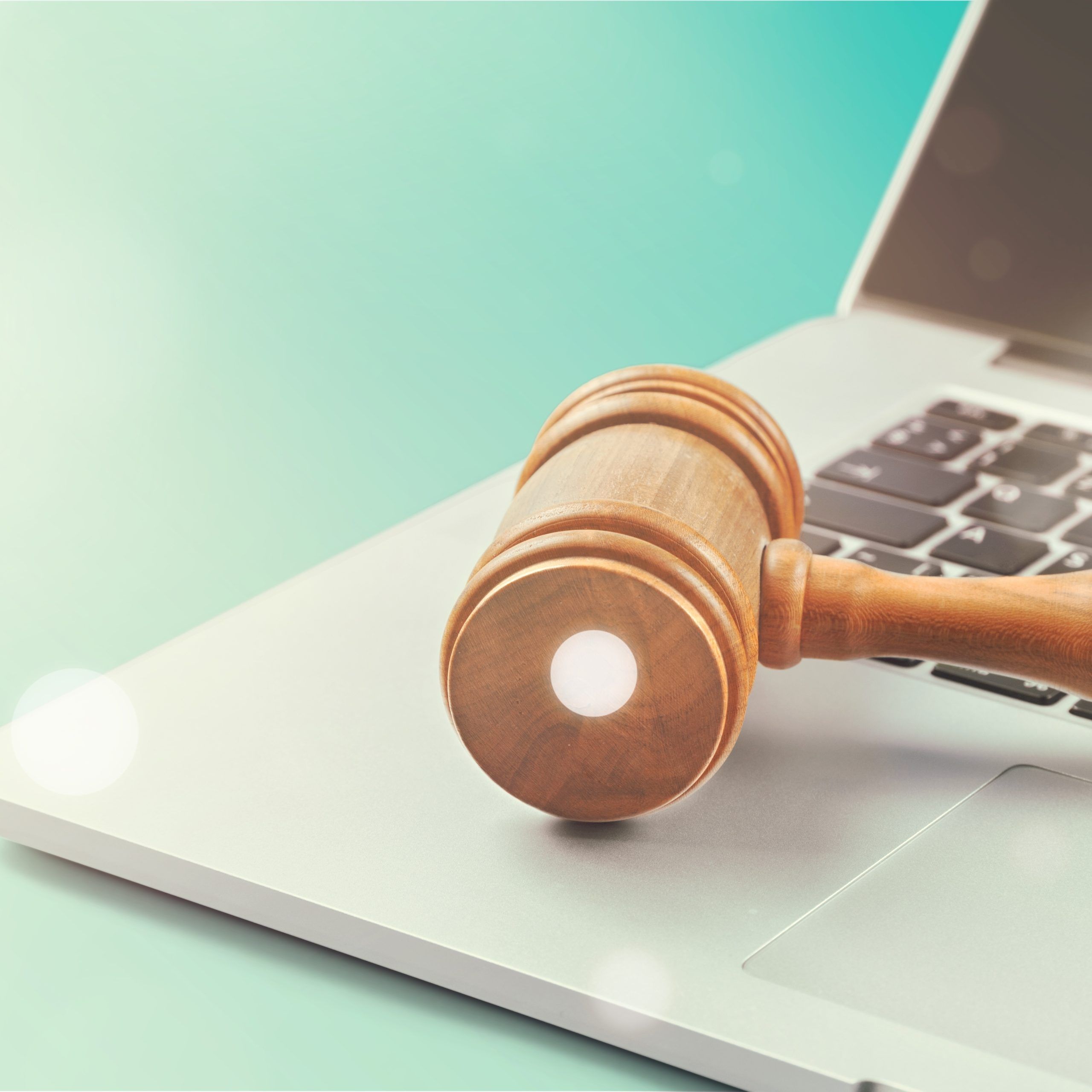 close-up-wooden-brown-gavel-laptop-scaled.jpg